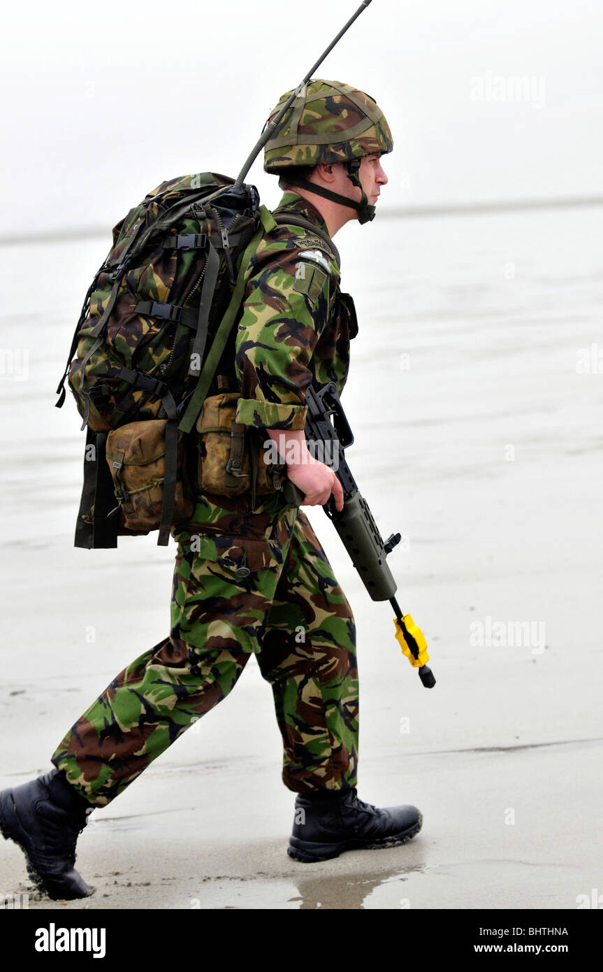 Communications Marine, soldier with communications radio during a beach landing, UK Stock Photo