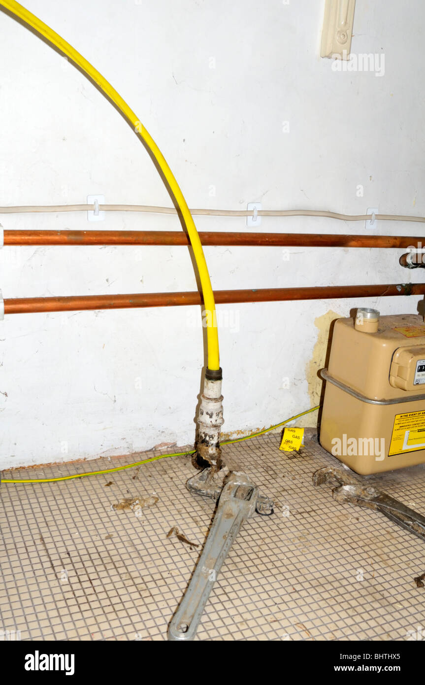 New yellow plastic gas pipe coming through the old metal pipe Stock