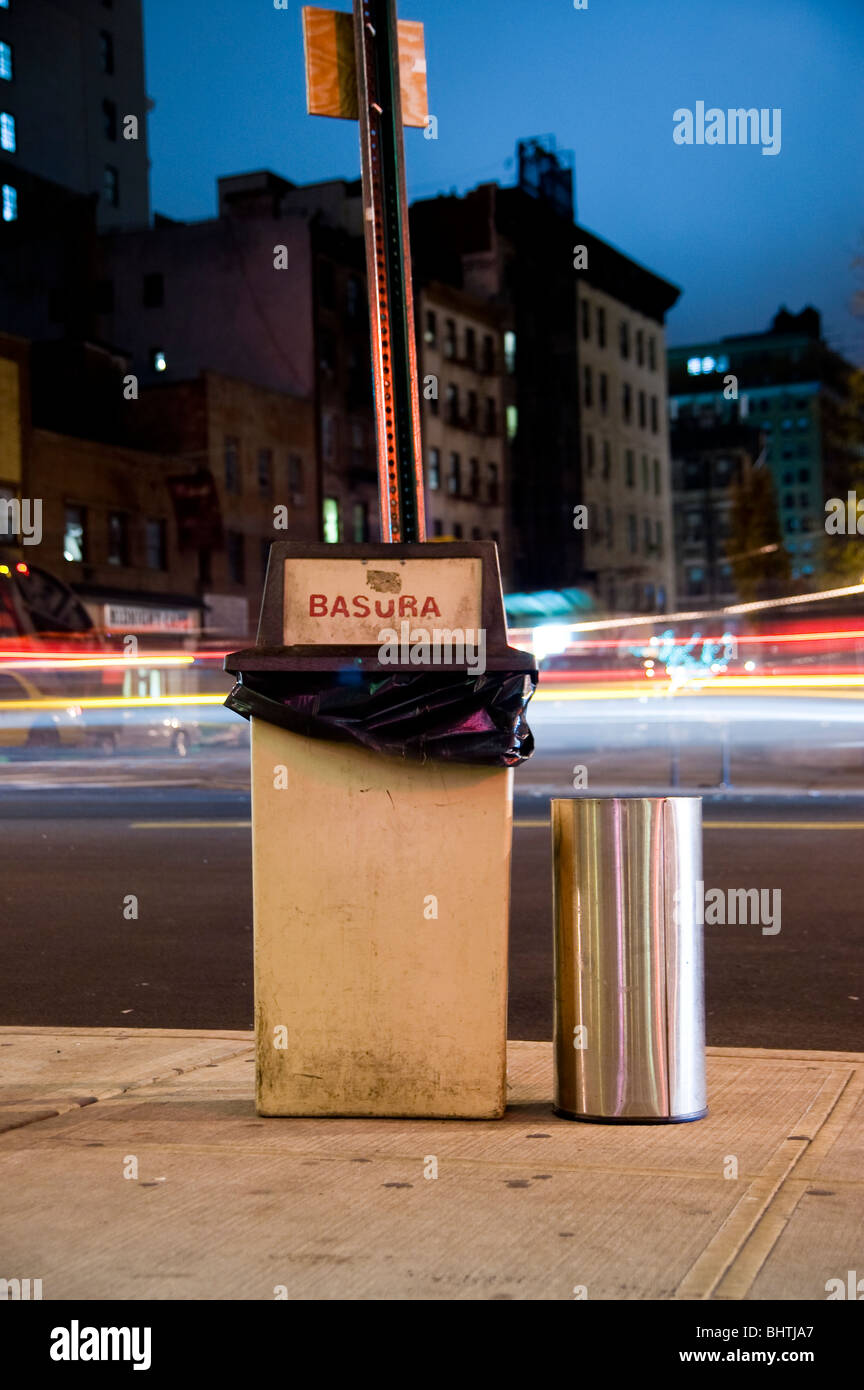 A trashcan and ashtray on a sidewalk. Stock Photo