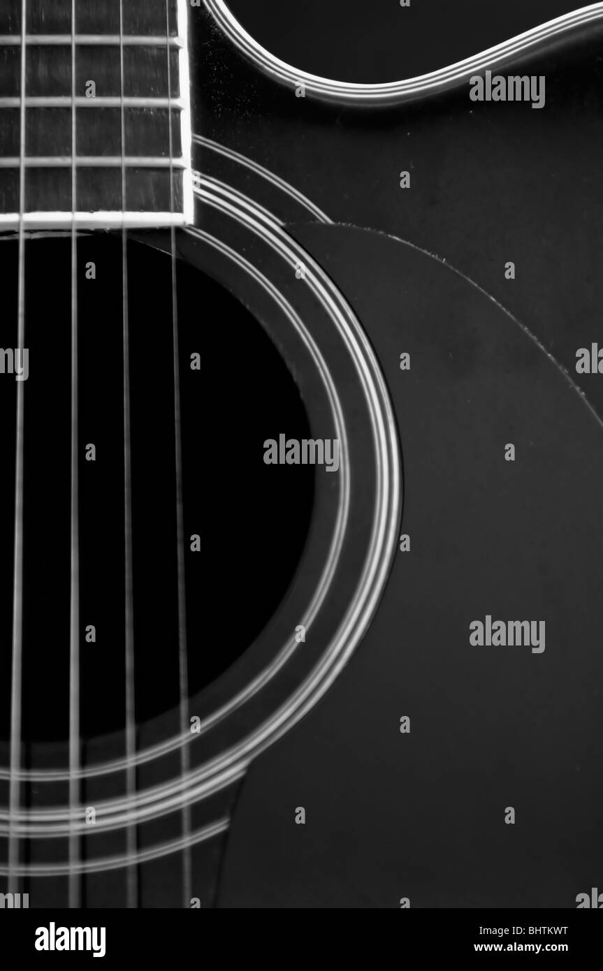 Close up of a guitar showing shapes and strings. Stock Photo