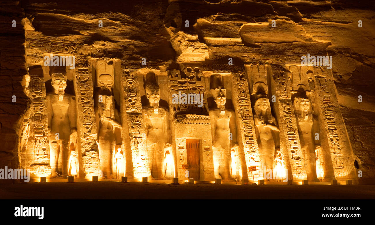 Floodlit carved statues Guarding the great temple of Hathor at the sound and light show in Abu Simbel, Egypt. Stock Photo