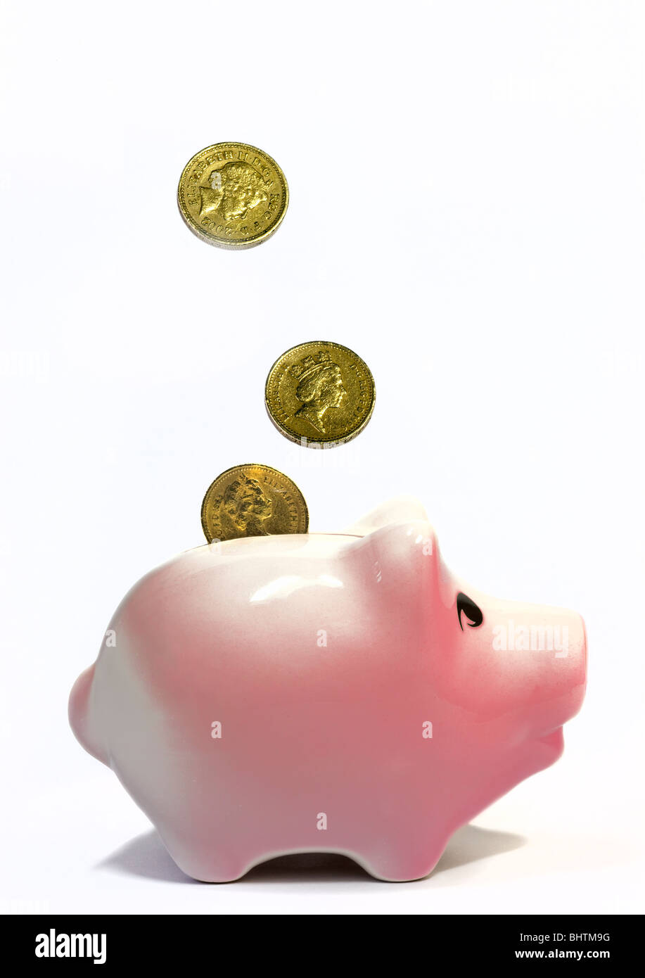 Pound Coins and Pink Piggy Bank Stock Photo