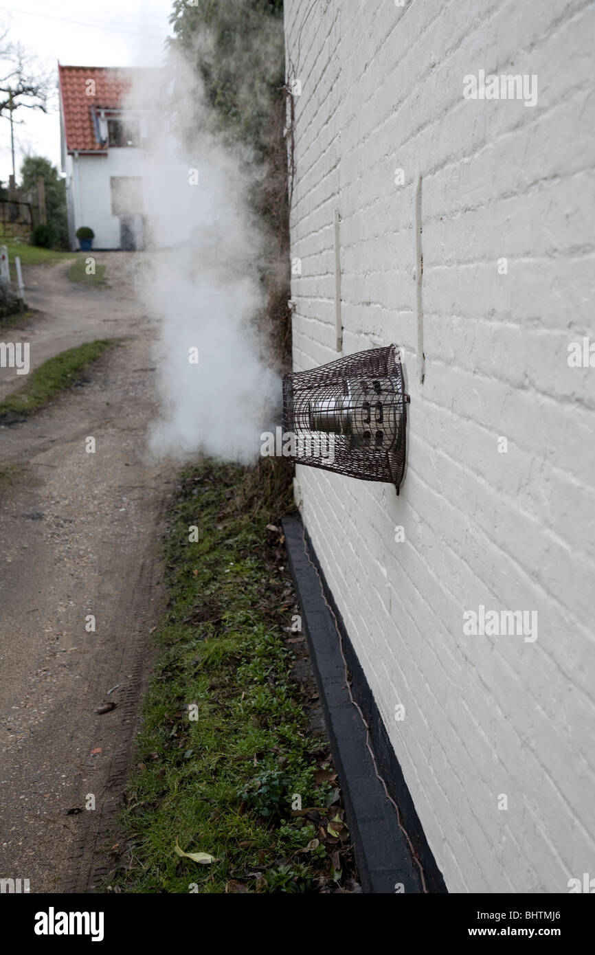 Steam heat emission from domestic heating system house exterior Stock Photo  - Alamy