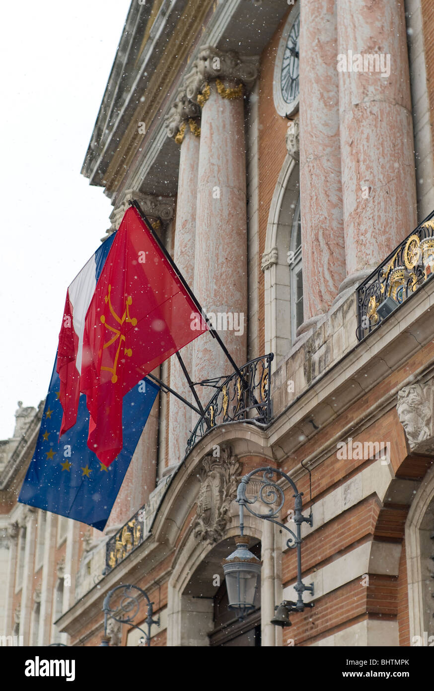 European, French Tricolore and Occitane flags outside the Capitole building, in Toulouse, the regional capital of Occitanie, France Stock Photo