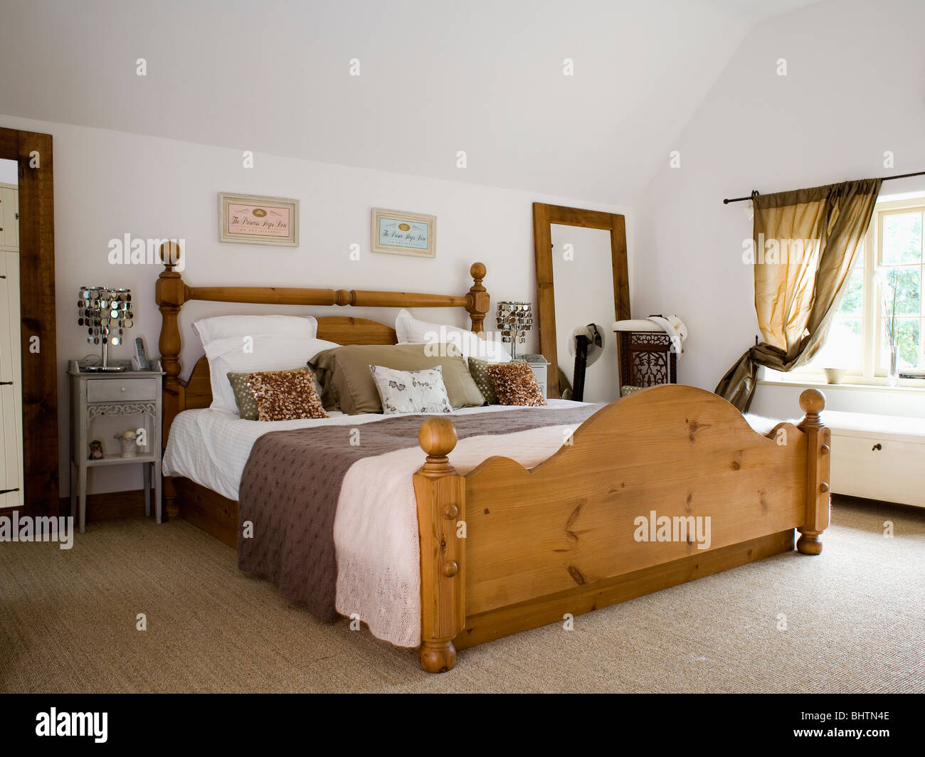 Large Pine Bed With White Bedlinen And Brown Throw In