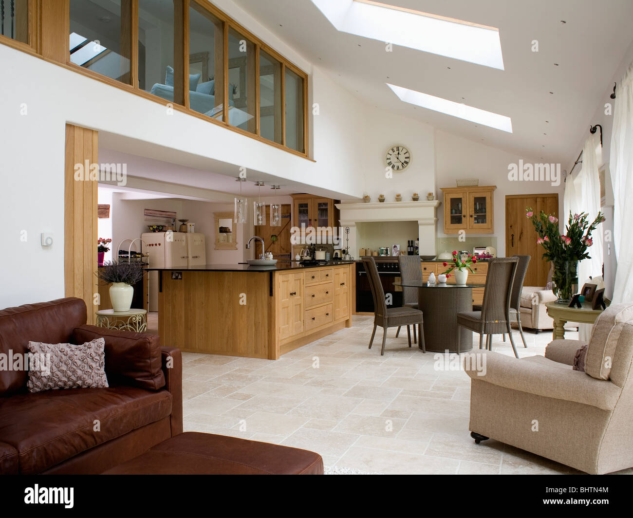 Limestone Flooring And Comfortable Armchairs In Large Modern Kitchen Dining Room Extension Limestone Flooring And Comfortable Armchairs In Large Modern Kitchen Dining Room Extension