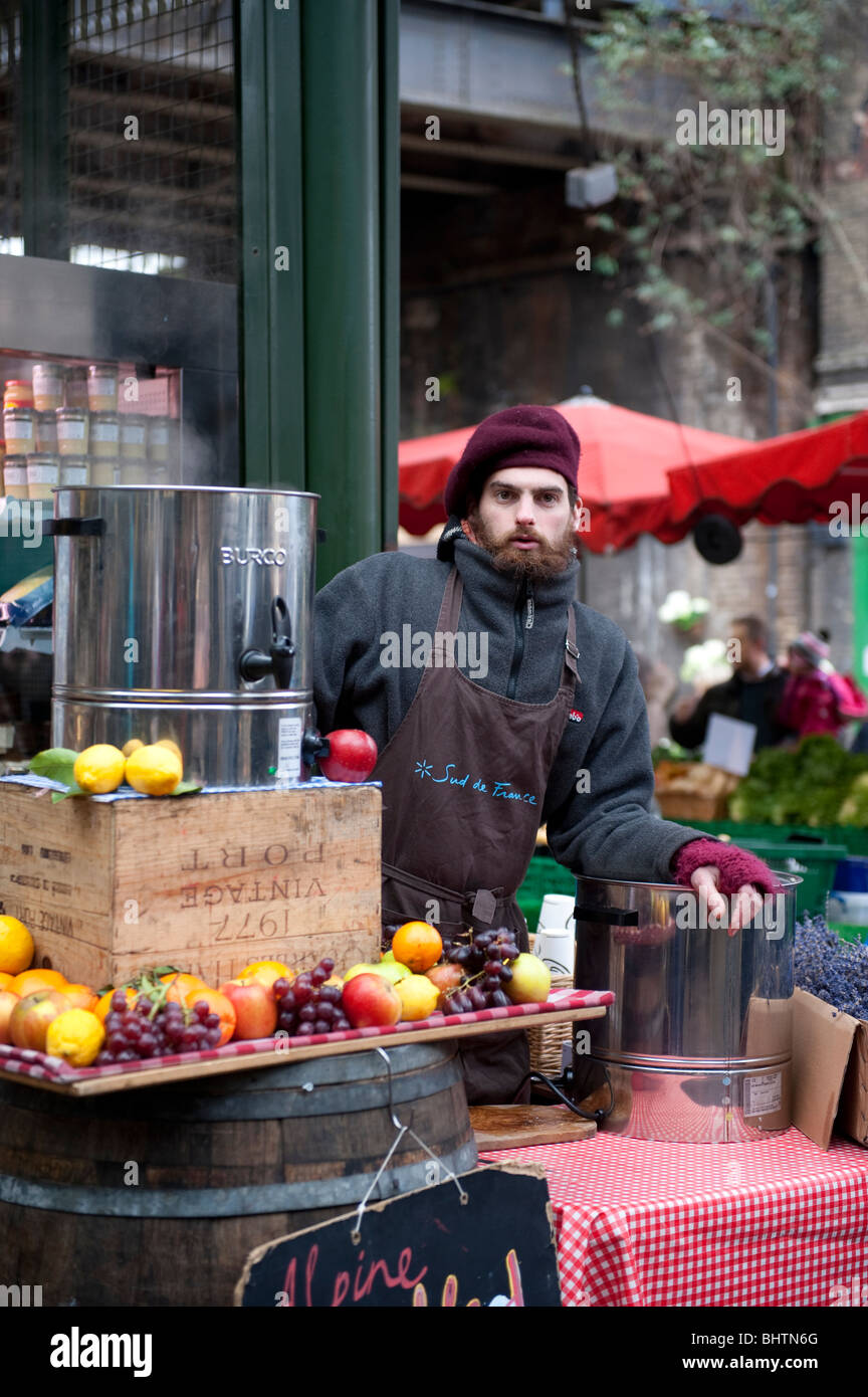 Market trader selling mulled wine, Borough Market, London Stock Photo