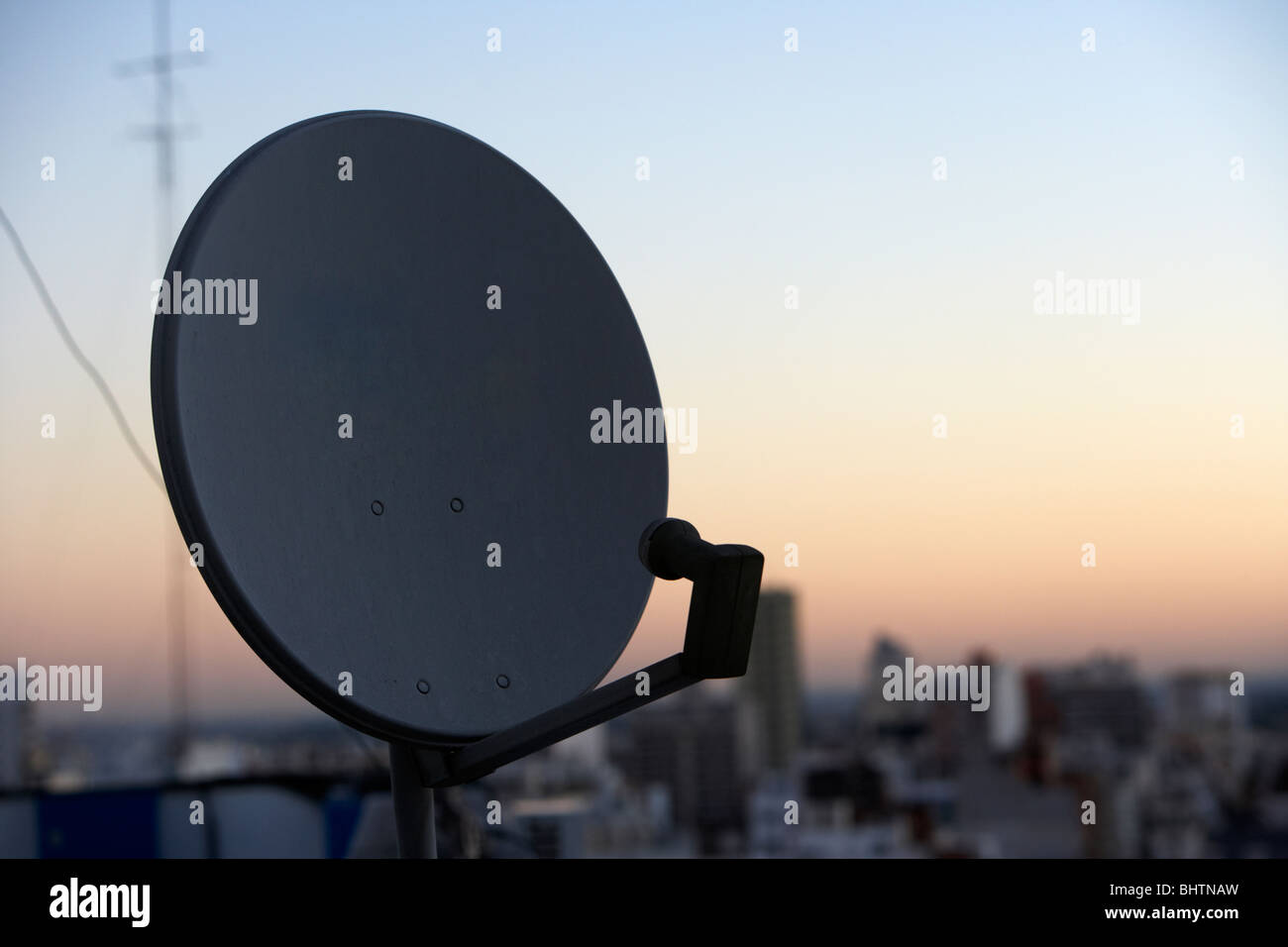 satellite television receiving dish on rooftops in the evening buenos aires argentina Stock Photo