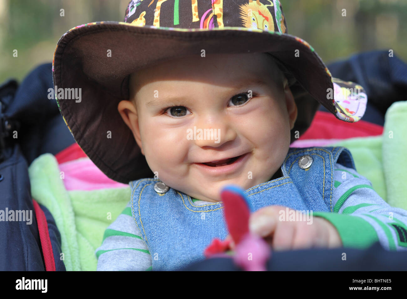 SMILING BABY WEARING A HAT Stock Photo