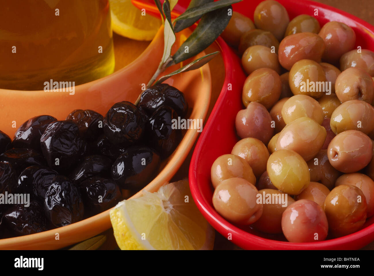 green and black olives with olive oil Stock Photo