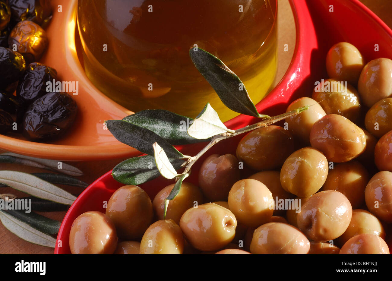 green and black olives with olive oil Stock Photo