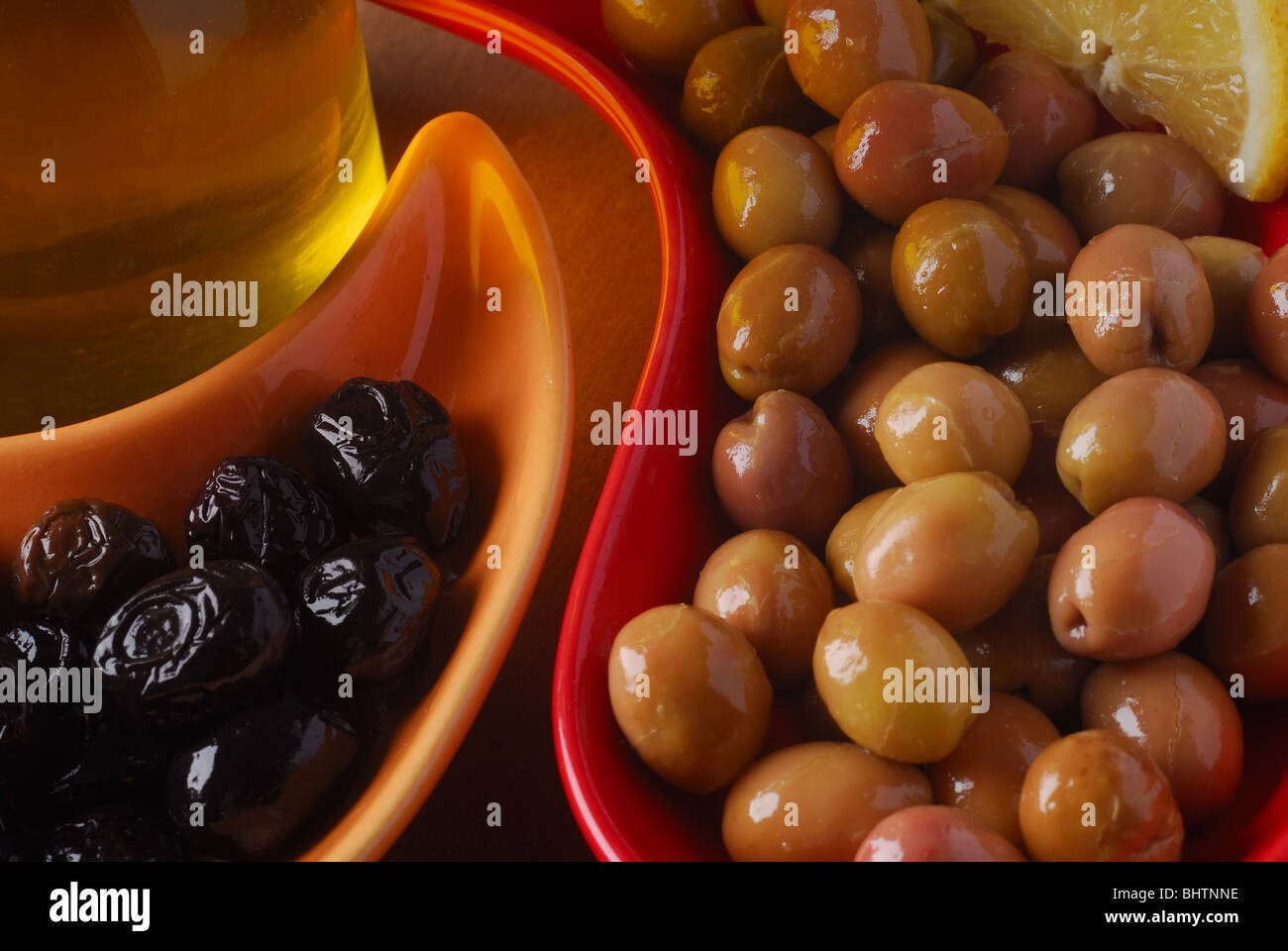 green and black olives with olive oil Stock Photo