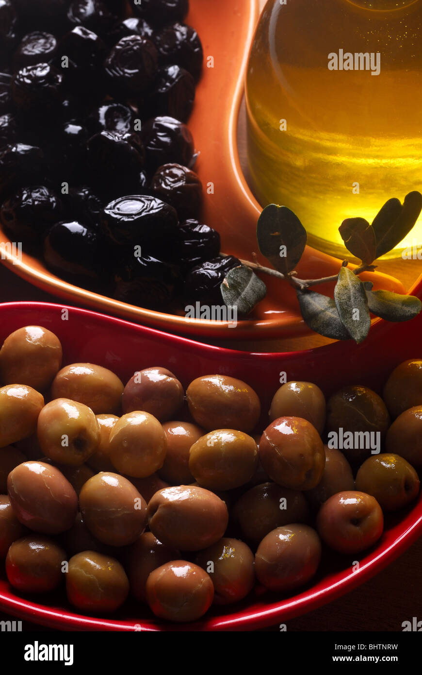 green and black olives with olive oil Stock Photo - Alamy