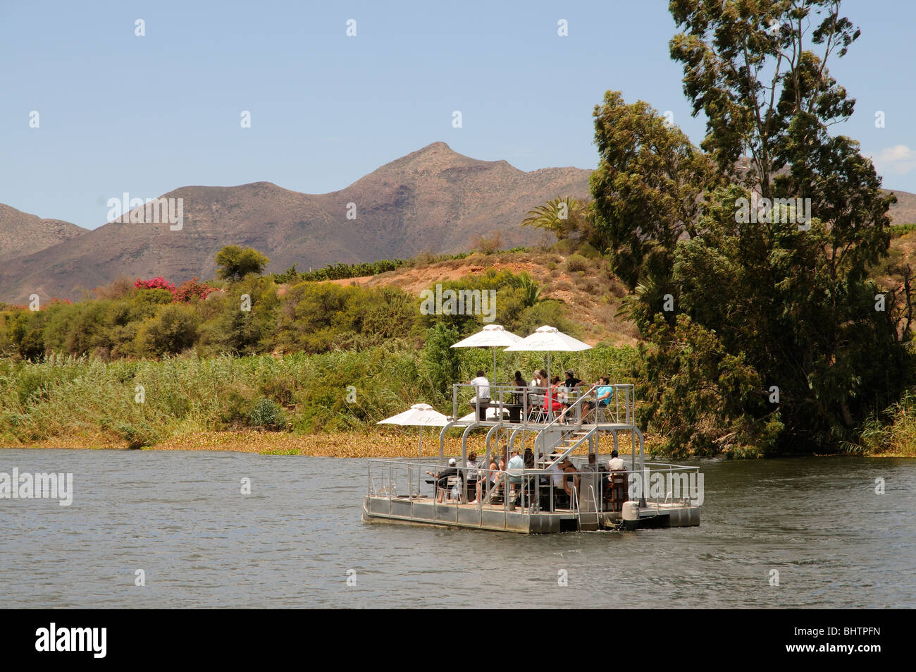 Breede River boat trip passing vineyards and mountains between Worcester and Roberstson western Cape South Africa Stock Photo