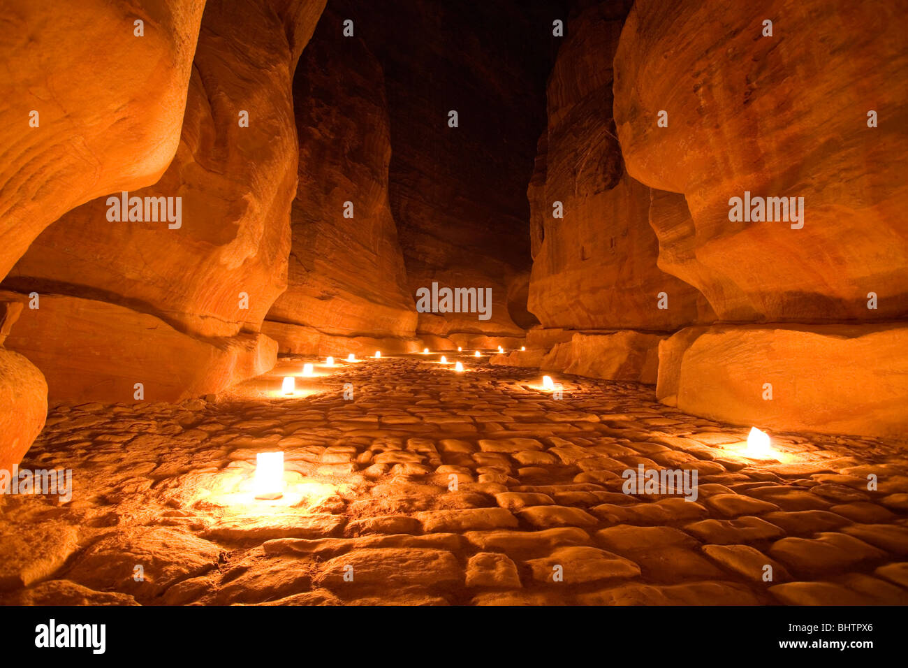 The Al-Siq Canyon leading to the Treasury lit up by candles for Petra by night in Wadi Musa, Jordan. Stock Photo