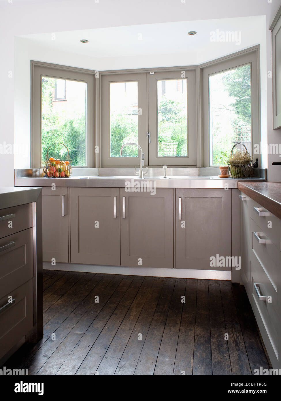 Dark Gray Wooden Flooring In Modern Kitchen With Gray Painted Fitted Stock Photo Alamy