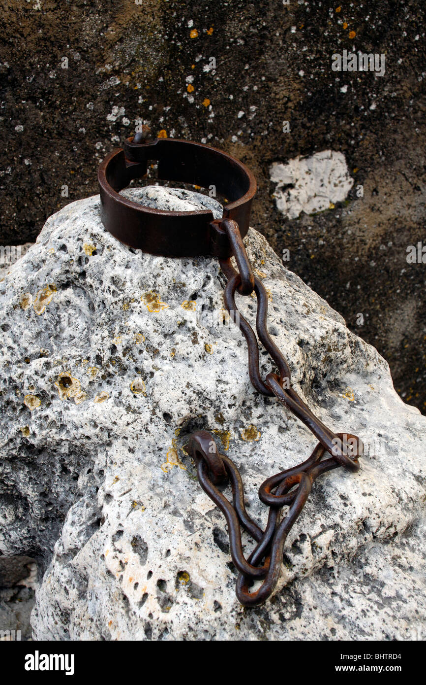 Collar and chain fixed to a rock Stock Photo