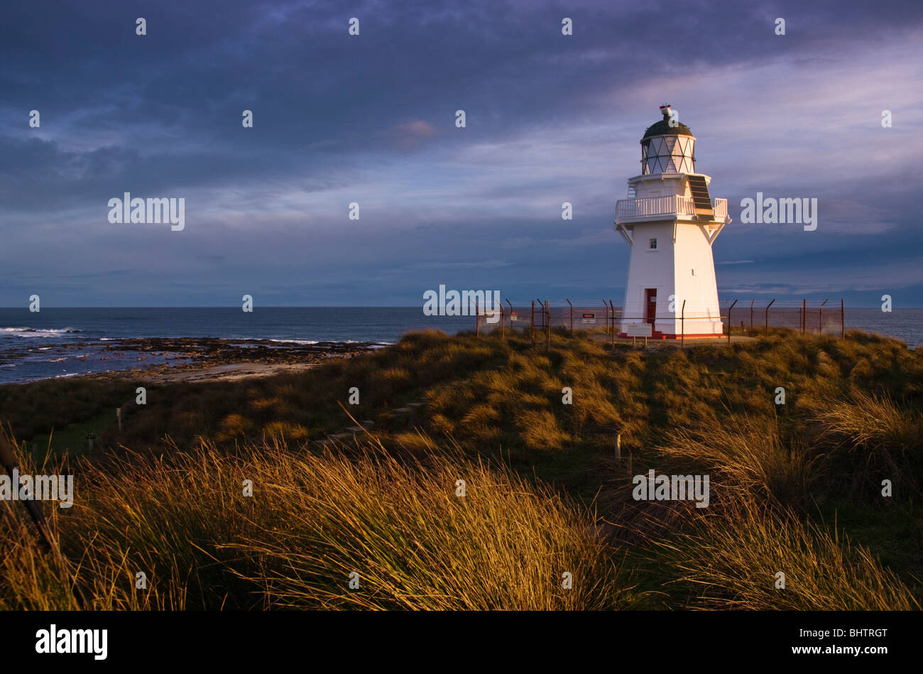 Waipapa Point lighthouse on the south coast of New Zealand's South Island. Evening light. Stock Photo