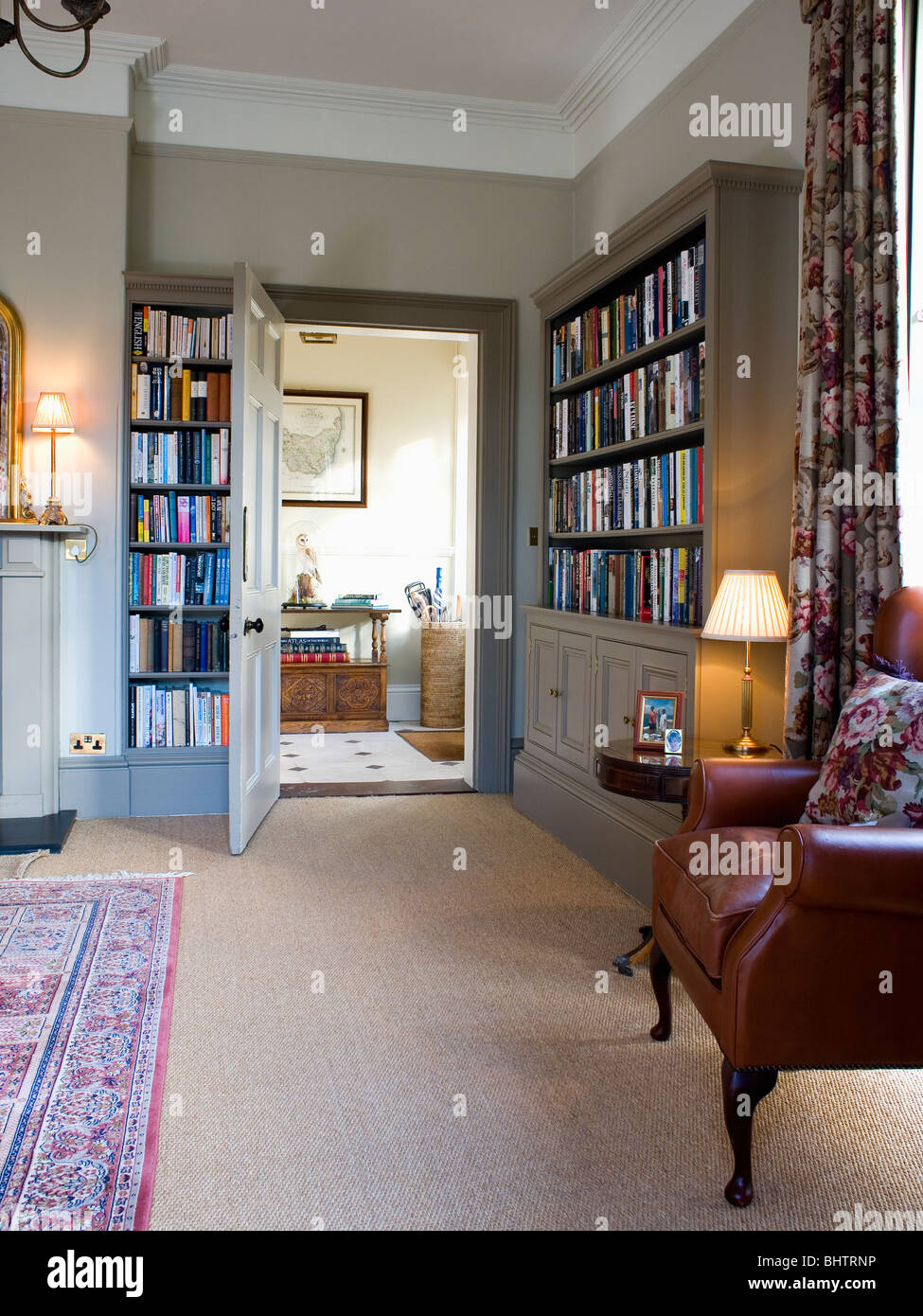 Beige carpet in living room with fitted bookshelves on either side of