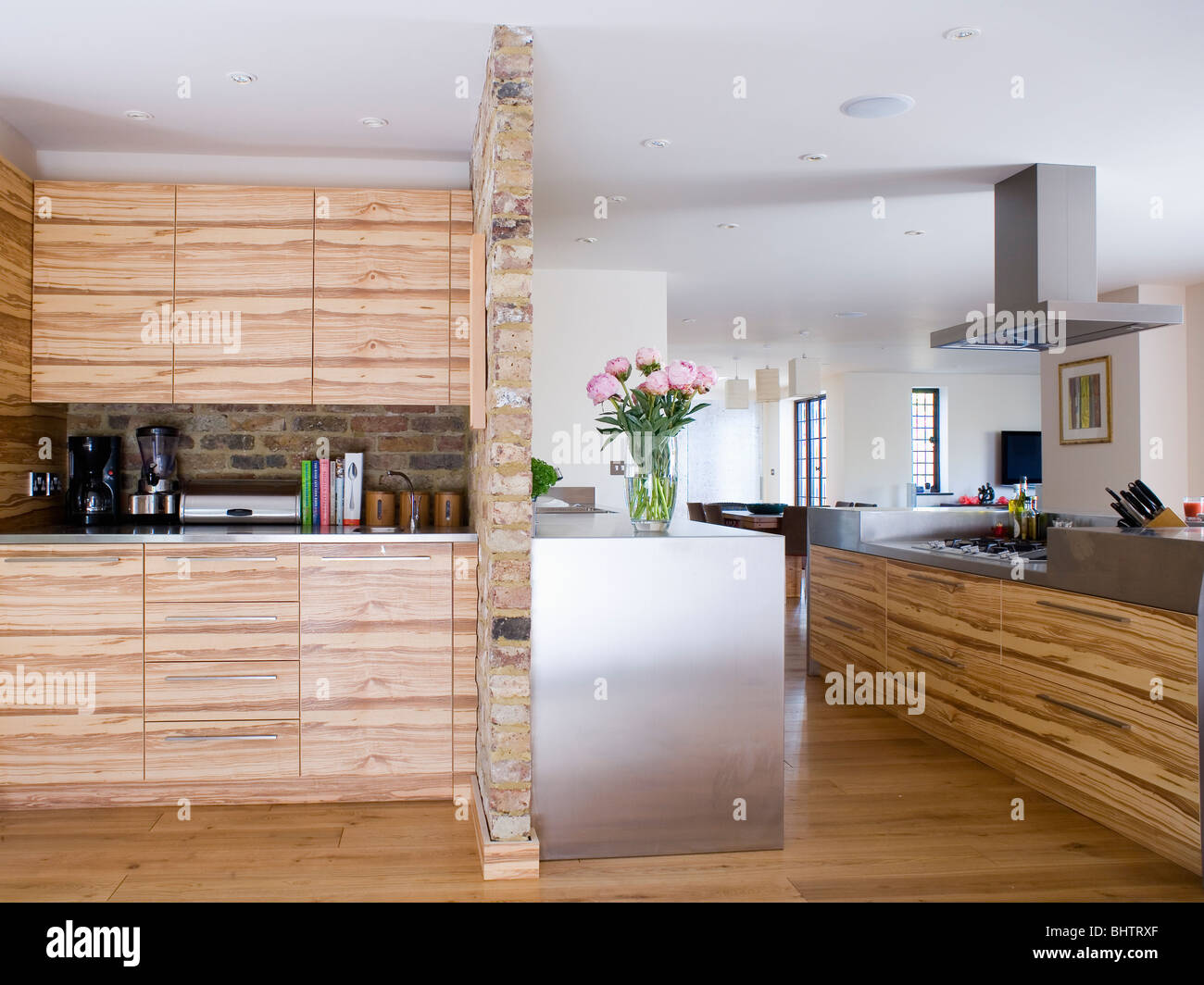 Veneered wood fitted units in large modern kitchen extension Stock Photo