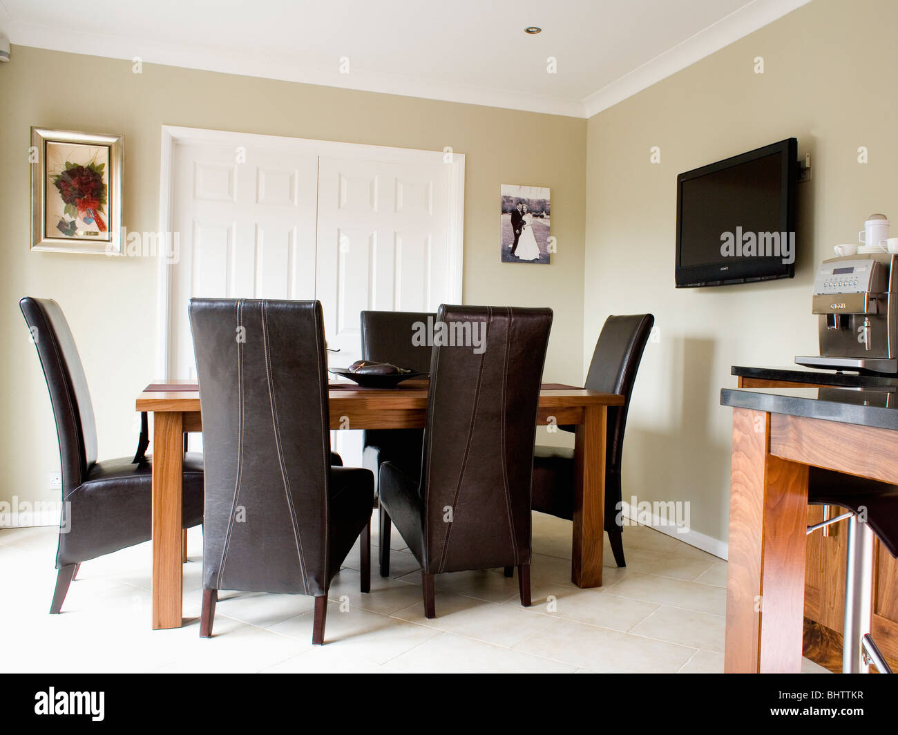 High Back Black Leather Chairs And Wood Table In Modern Beige Dining Stock Photo Alamy