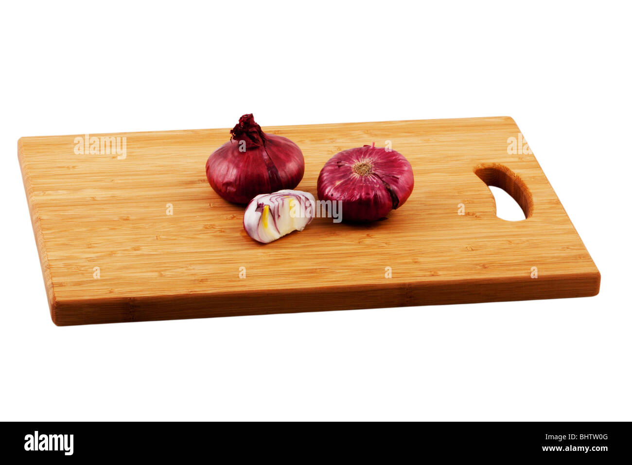 Whole and cut onions on a chopping board Stock Photo - Alamy