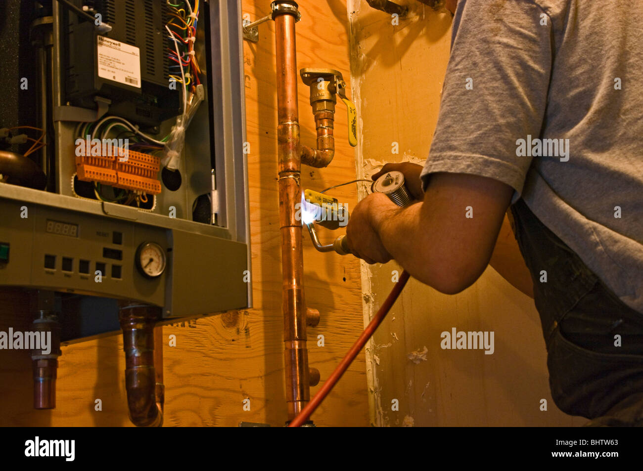 Plumber soldering copper pipes Stock Photo Alamy