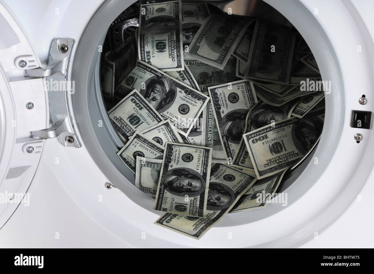 Money laundering concept - 100 dollar bills laundered in a washing machine. Stock Photo