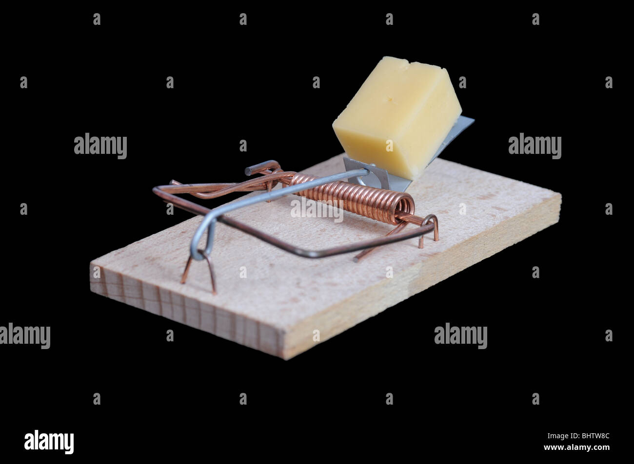 Mousetrap with a piece of cheese on black background. Stock Photo