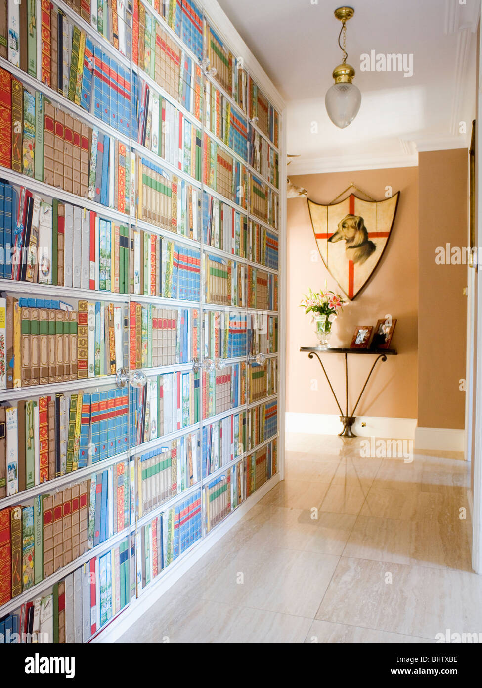 Trompe-l'oeil bookshelves in country hall with limestone flooring Stock Photo