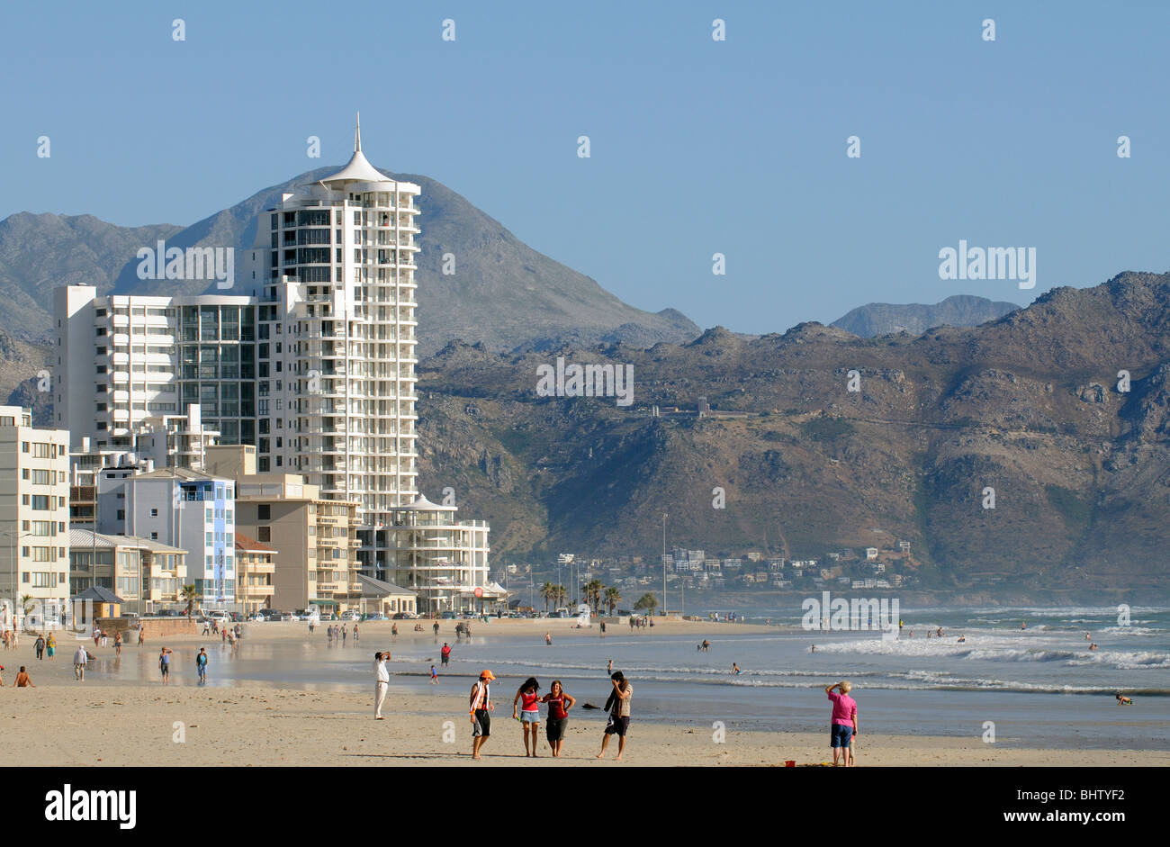 Holidaymakers Walking On The Beach In The Western Cape