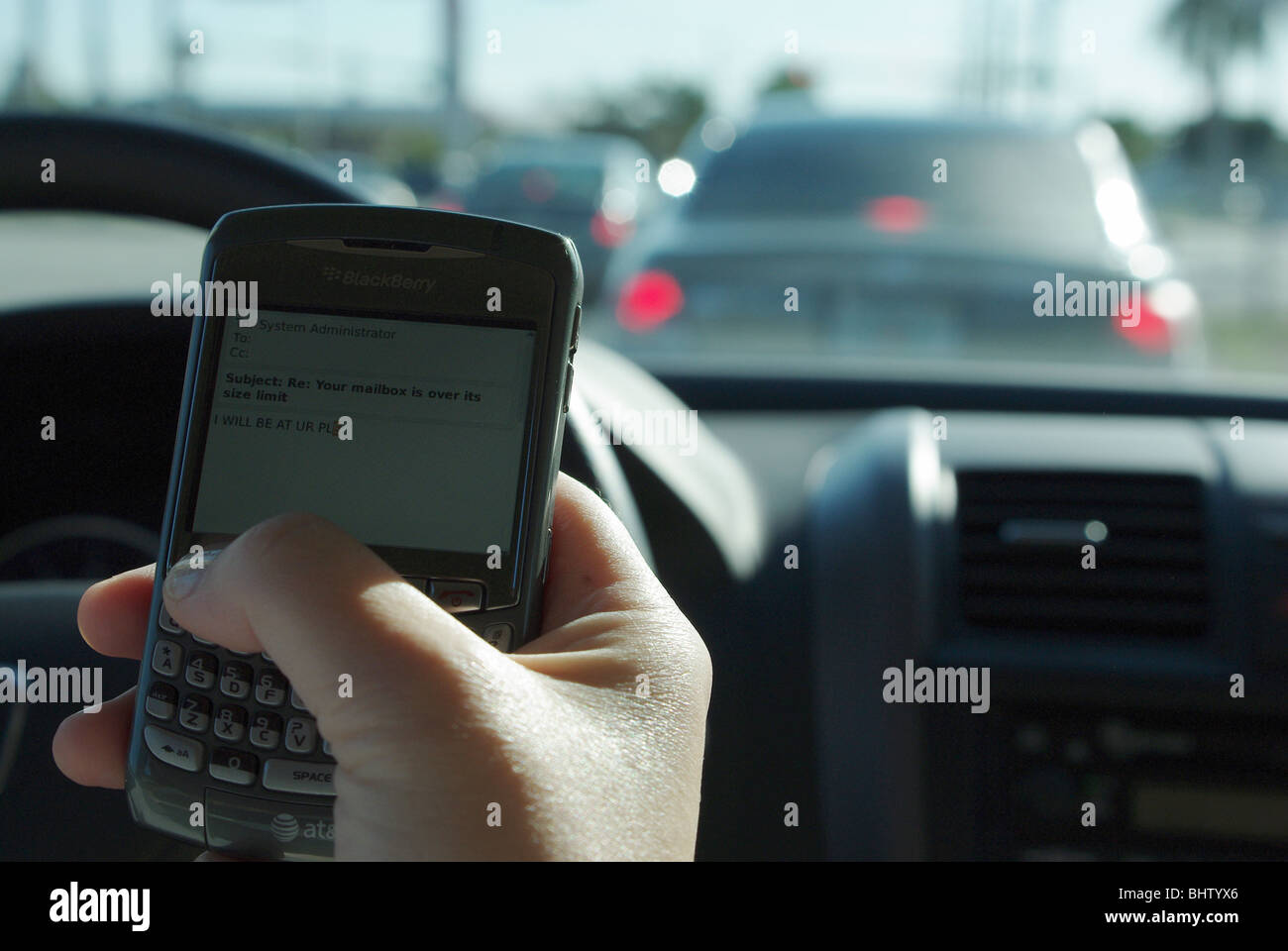 Woman is using PDA to check and type text messages while driving her