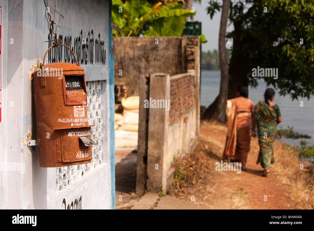 India, Kerala, Alappuzha, backwaters, Chennamkary, postal box hanging on riverside wall Stock Photo
