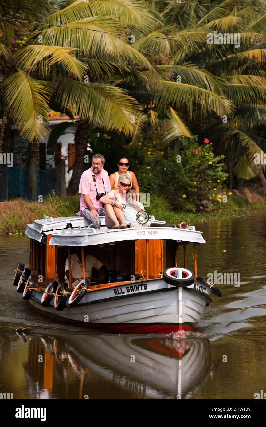 India, Kerala, Alappuzha, Chennamkary, western visitor sitting on top of small sightseeing boat Stock Photo