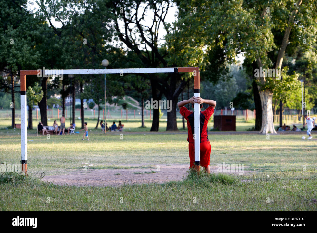 young boy leaning up against goalposts in a football game in the park in buenos aires argentina south america Stock Photo