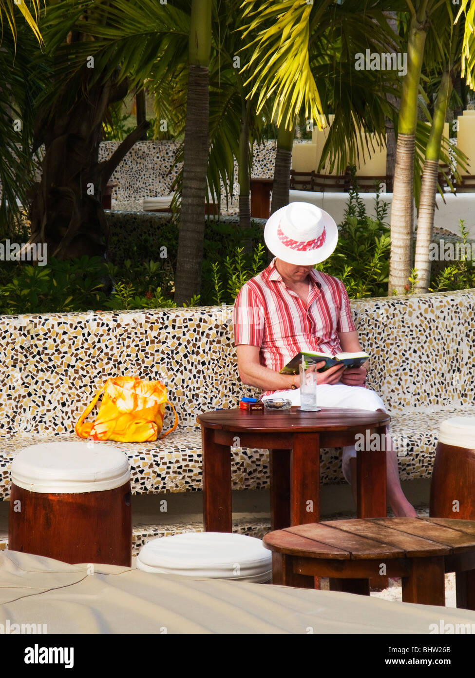 Reading by the pool stock photo alamy