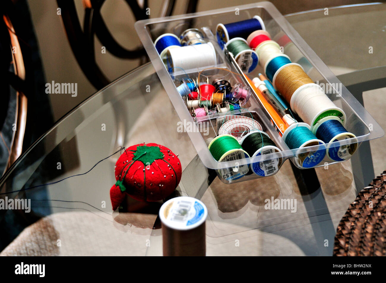A sewing tray filled with spools of thread and other sewing items Stock ...