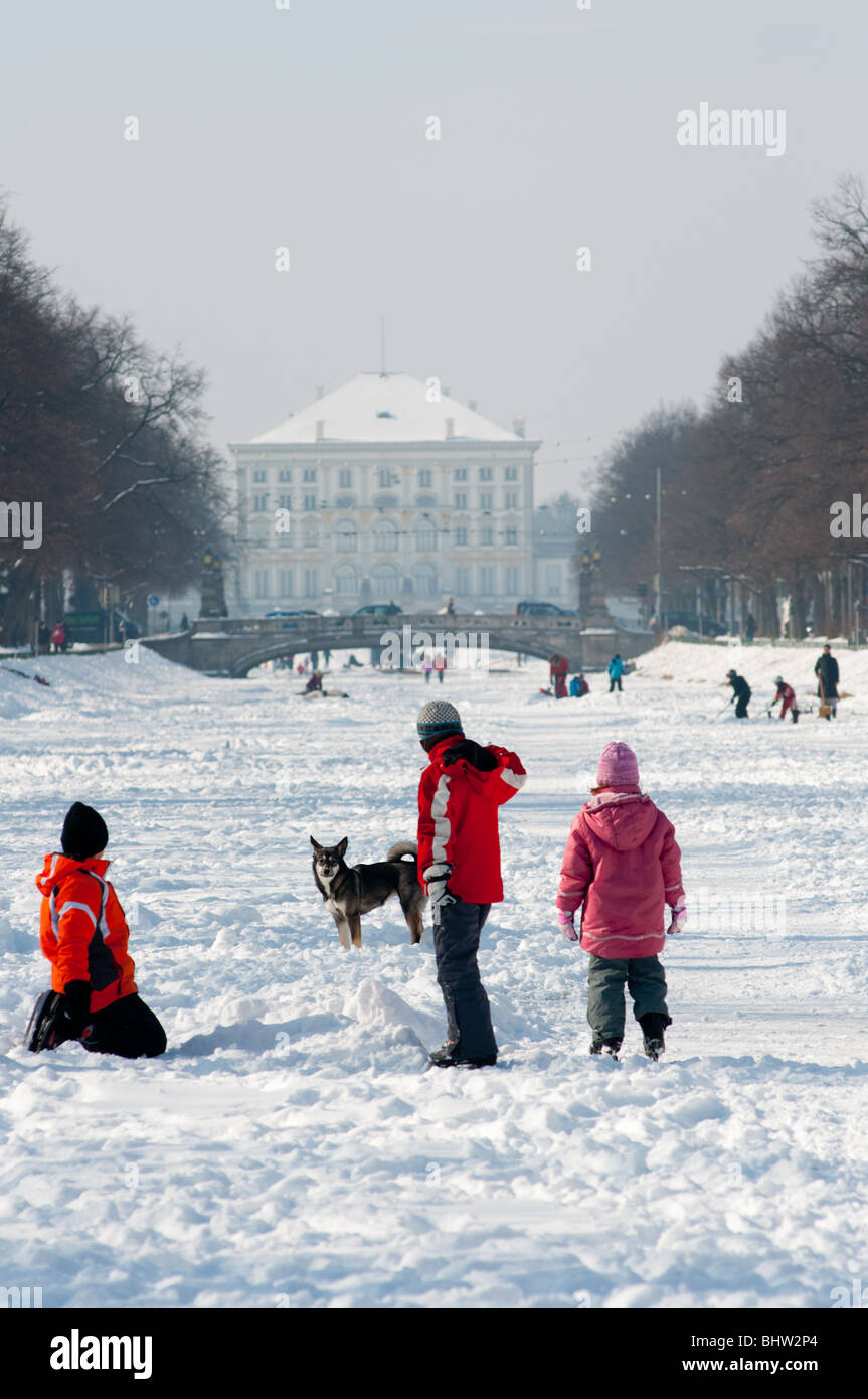 Fun on the frozen canal leading to Nymphenburg palace in Munich. Stock Photo