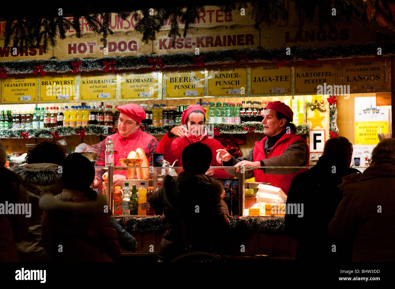 hot dog sellers in  santa hats and outfits at the christmas fair at the rathaus vienna austria Stock Photo