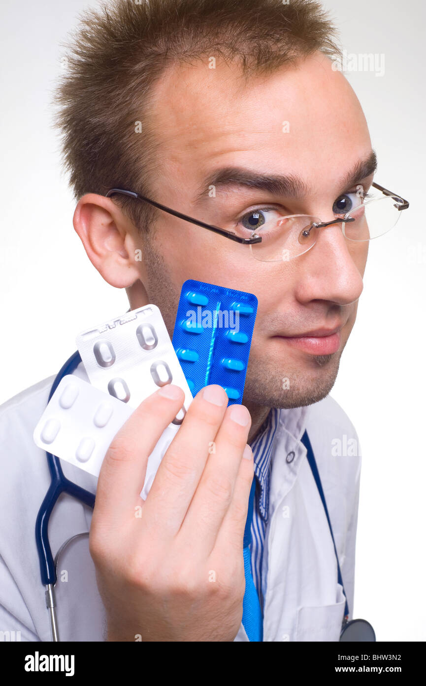 young male doctor holding blisters of pills Stock Photo