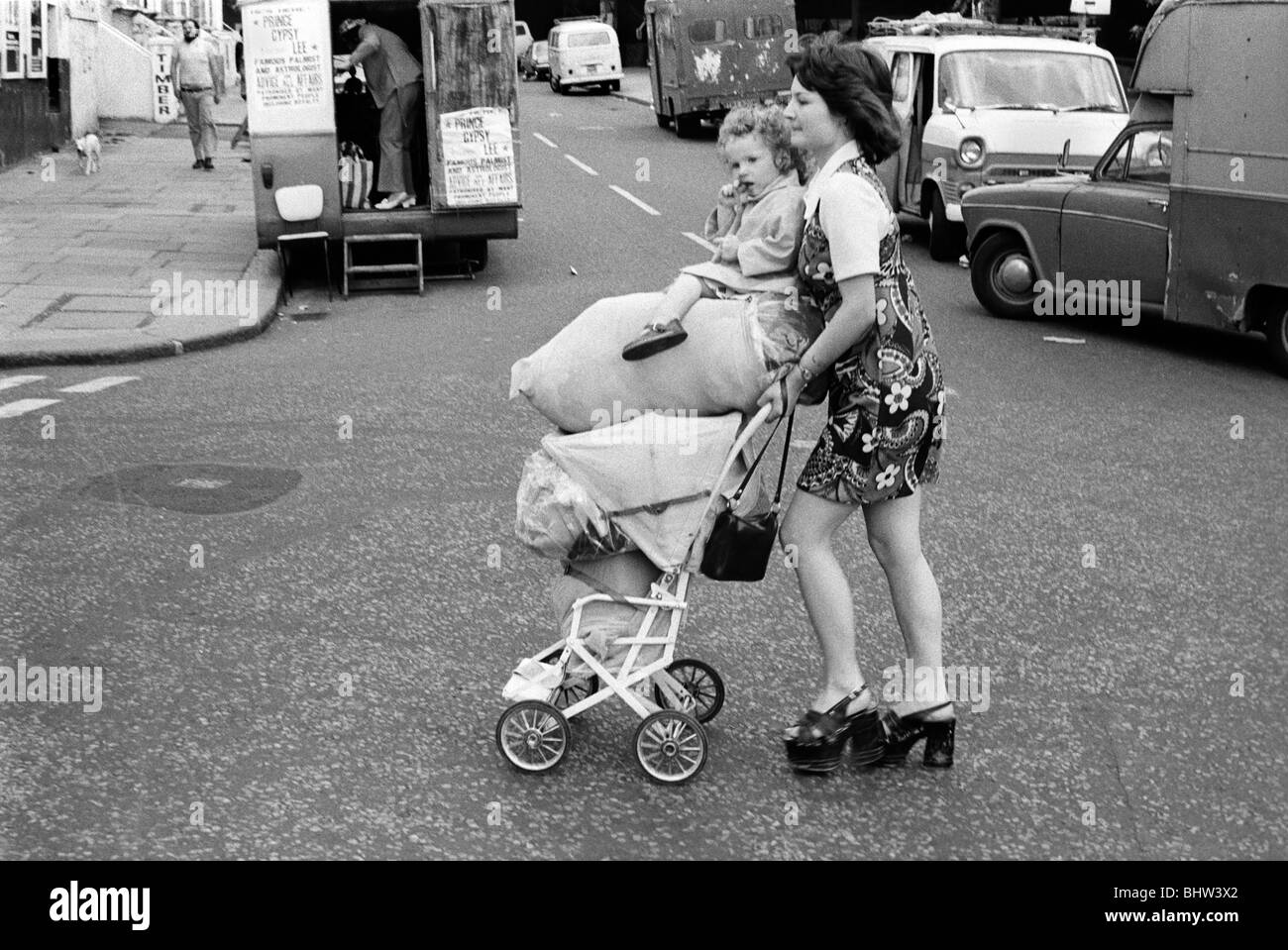 Teenager 1970s UK. Young girl with baby sister returning from shopping trip bags of potato's Notting Hill west London UK 1975 70s England HOMER SYKES Stock Photo