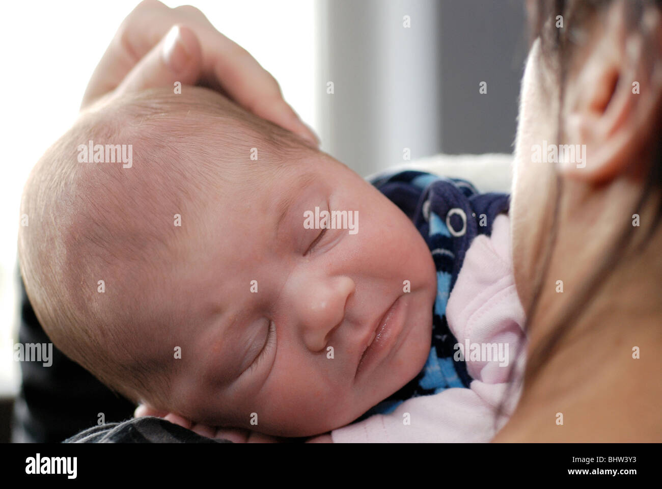 Little baby sleeping in mother arms Stock Photo
