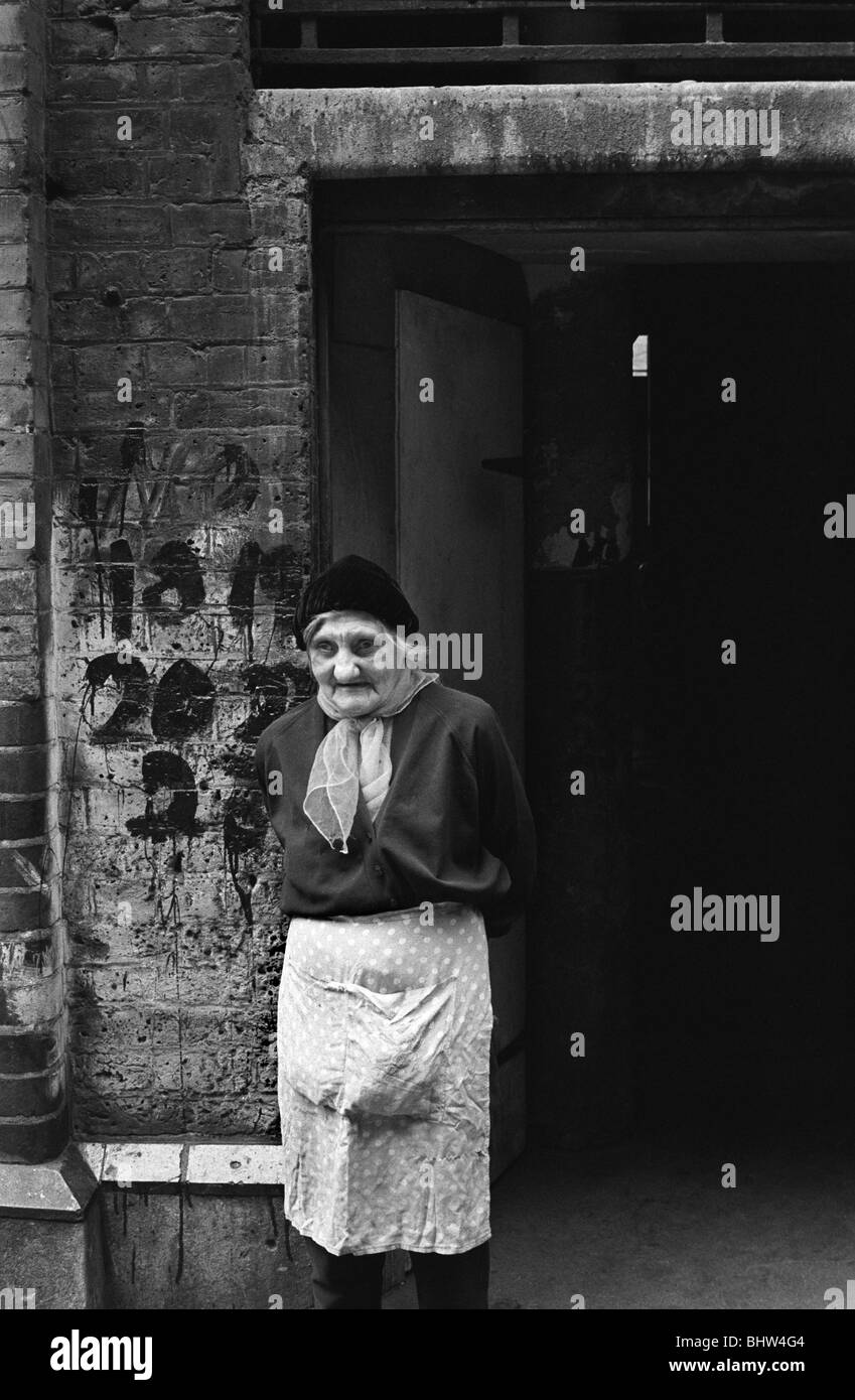Victorian slums 1970s UK. Peabody Housing Estate. Tower Hamlets Whitechapel east London. Poor elderly Jewish lady outside her home. 1975 HOMER SYKES Stock Photo