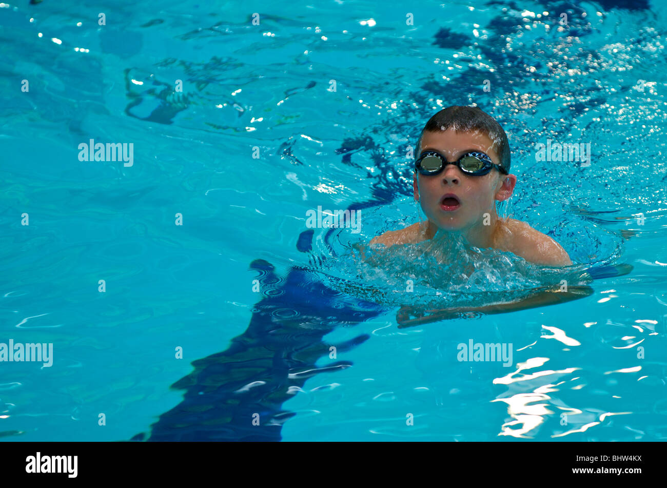 Boy swimming in a swimming pool of clear water Stock Photo - Alamy