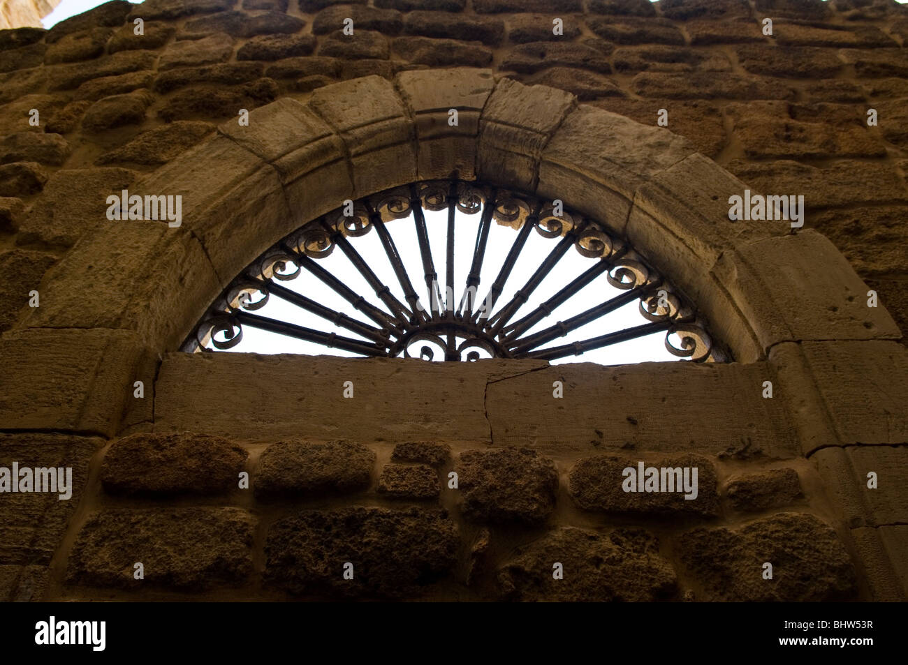 Old arched window in a stone wall in Saida Lebanon Middle East Stock Photo