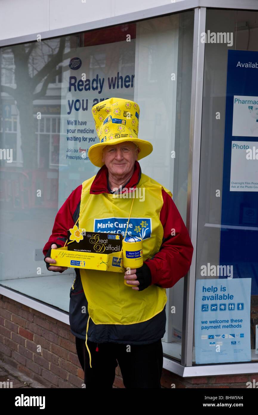 Marie Curie charity collector holding a collection box outside a shop in Chesham Buckinghamshire UK Stock Photo