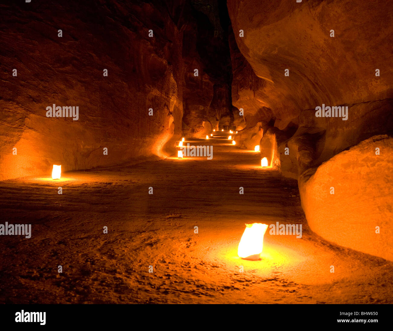 The Al-Siq Canyon leading to the Treasury lit up by candles for Petra by night in Wadi Musa, Jordan. Stock Photo