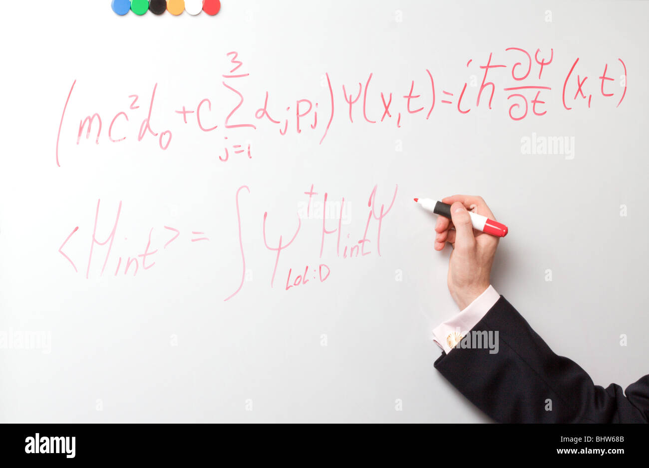 Hand writing formulas a red felt-tip pen on a board Stock Photo