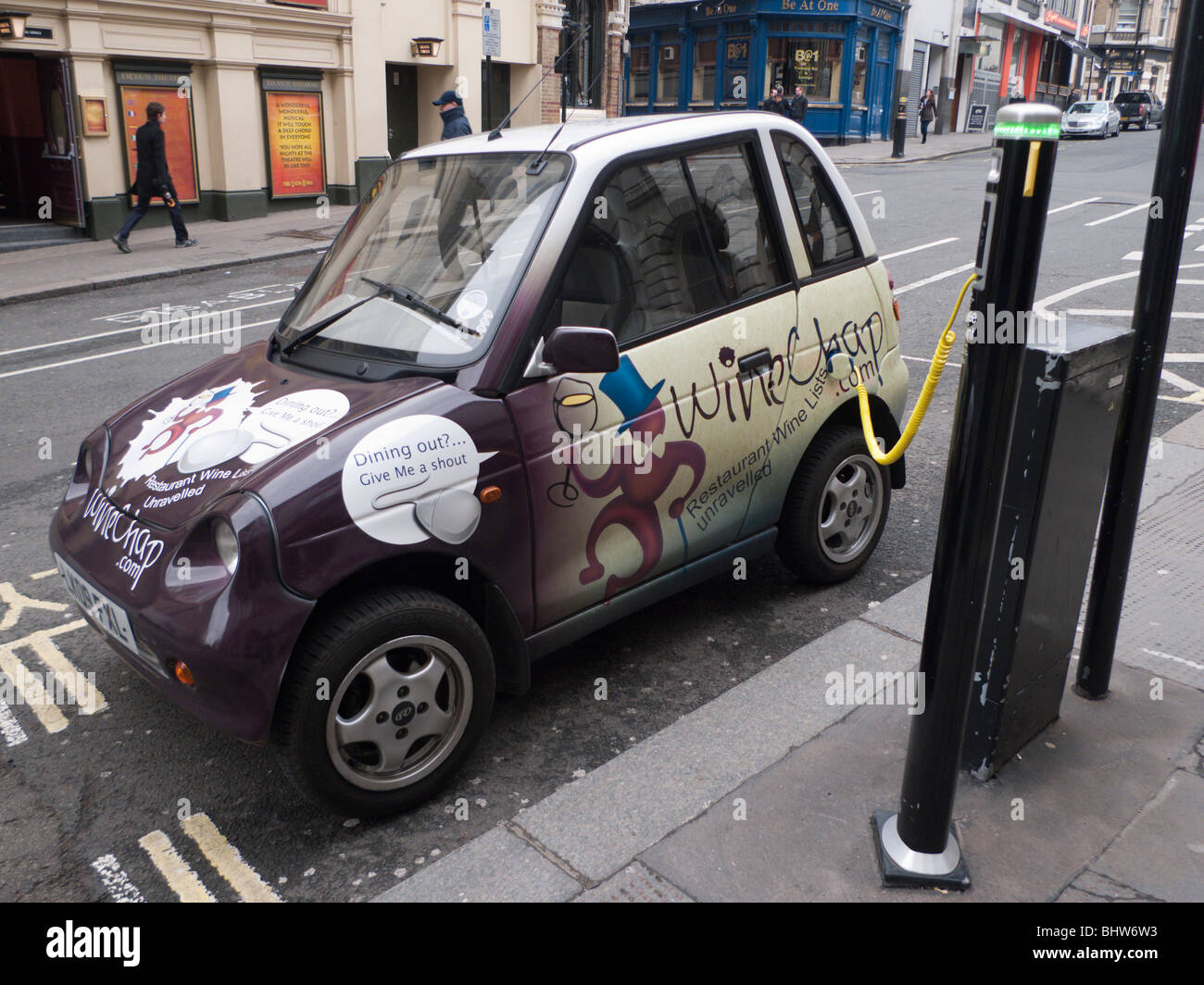 eco friendly electric car Reva city car recharges at street recharge point in Covent Garden, London Stock Photo