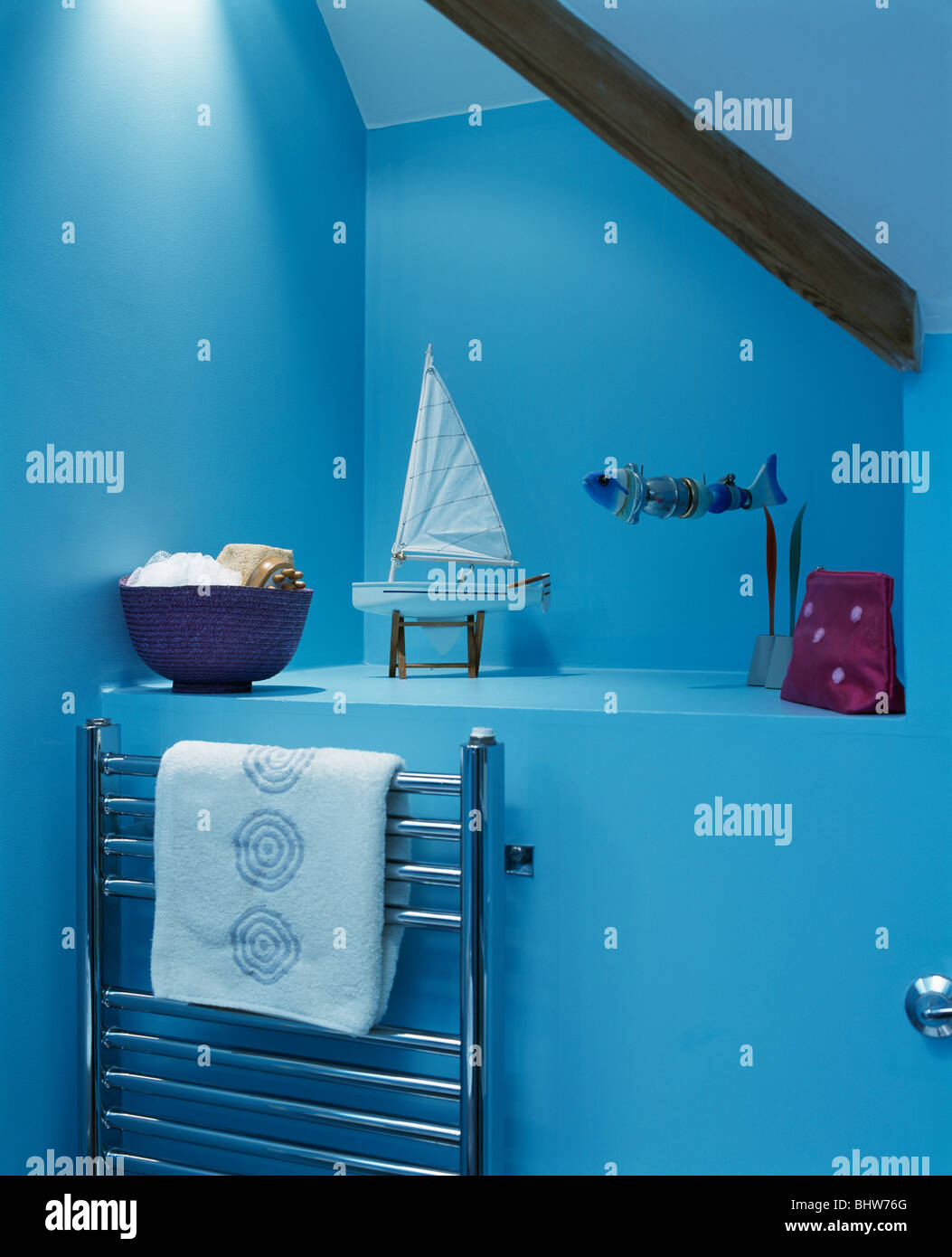 Large alcove above stainless-steel radiator in modern blue attic ...